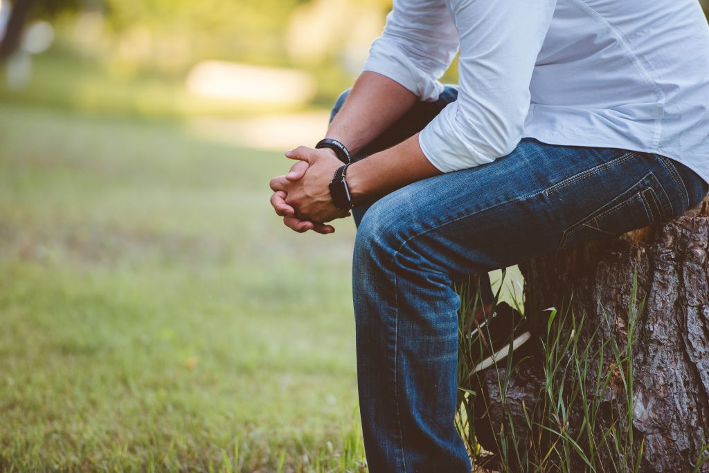 Man in white shirt sitting