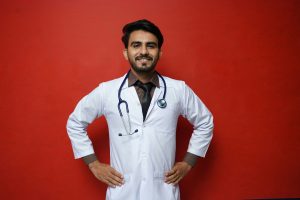 Man in white shirt standing upright