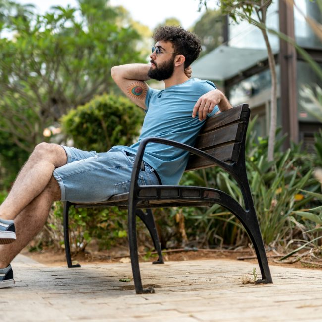 Man sitting on a bench in park Man sitting on a bench in park